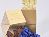 a bottle of perfume sitting next to a blue bag