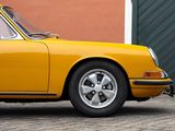 a yellow car that is parked in front of a building