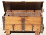 a wooden chest with a metal latch on it