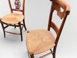 pair of antique wooden chairs with wicker seat and back