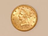 a close up of a gold coin with a woman ' s head on it