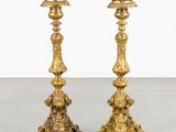 pair of antique brass candlesticks on marble floor