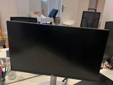 a desk with a computer monitor, mouse, and other items on it