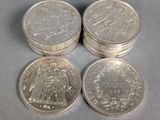 four silver coins sitting on top of each other on top of a table