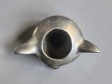 a silver teapot that is sitting on a table