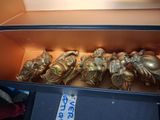 a bunch of gold figurines sitting in a box