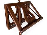 a wooden instrument stand with a guitar on top of it