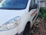 a white van that is parked next to a building