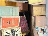 many books stacked on top of each other in a box