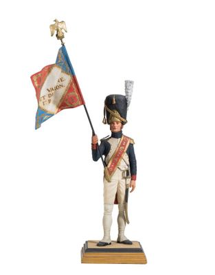 figurine of a soldier holding a flag and a flag pole