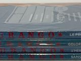 four books stacked on top of each other on a table