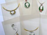 many different types of jewelry displayed on display in a display case