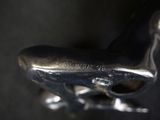 a close up of a metal object on a black surface