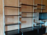 a black entertainment center with a flat screen tv in the corner