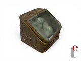 an antique brass box with a glass window on a white background
