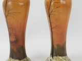 two vases that have been painted with trees on them