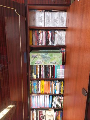 a book case with many books on it in the corner of a room