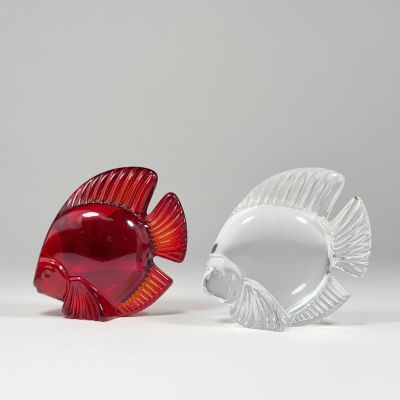 pair of red and clear glass fish figurines on a white surface