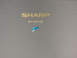 a close up of a laptop with a sharp logo on it