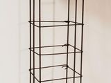 a close up of a metal rack with a shelf on it