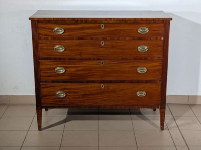 a wooden chest of drawers in a room with tile flooring