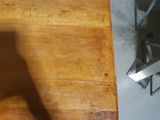 a wooden table with a metal chair next to it