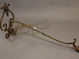 an image of a gold plated metal object with a long handle