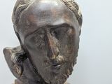 a statue of a man with a beard on a pedestal