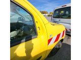 a yellow truck with a red and white stripe on the side of it