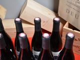 several bottles of red wine are lined up on a red tray