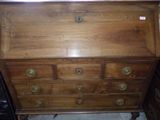 a wooden dresser with brass knobs on it