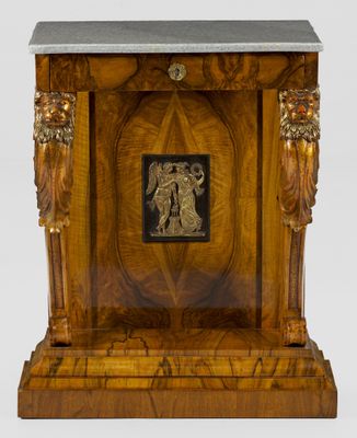 a wooden table with a marble top and a statue on it