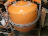 an orange tank sitting on top of a cart in a garage
