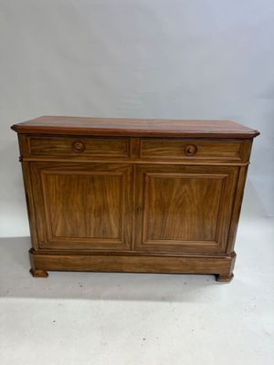 an old wooden cabinet with two drawers and two doors