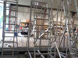many scaffoldings that are in a building that is under construction