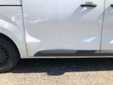 a small white van parked on the side of the road