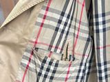 a jacket with a checkered pattern on it hanging on a wall