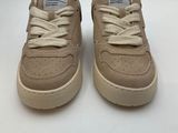 a pair of beige sneakers with white laces on them