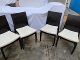 quatre chaises noires et blanches recouvertes de housses blanches