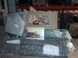 a pile of assorted items sitting on a pallet in a warehouse