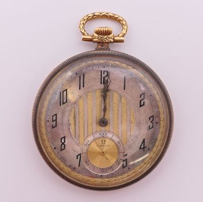 a close up of a pocket watch on a white surface