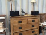 a dresser with a laptop on top of it in a room