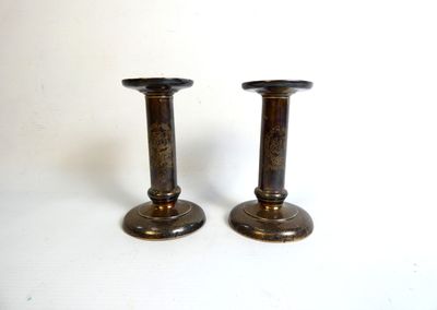 pair of antique brass candlesticks on a white background