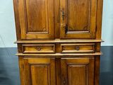 un vieux meuble en bois avec deux portes et deux tiroirs