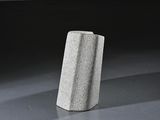 a stone block sitting on the floor in a dark room