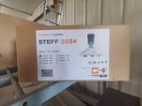 someone is holding up a box with a blender in it