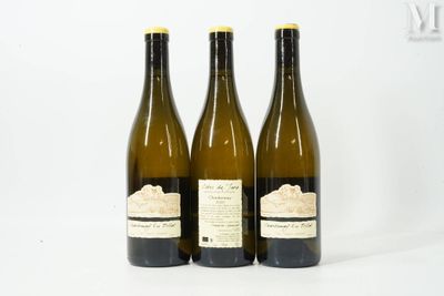 three bottles of wine sitting next to each other on a white surface