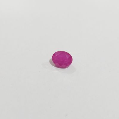 a pink oval stone on a white surface