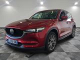 a red mazda cx - 5 parked on a checkered floor