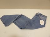 denim pants on a table with a price tag on it